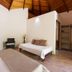 Blue World Dharavandhoo room with wood ceiling, twin beds, and open closet in Dharavandhoo