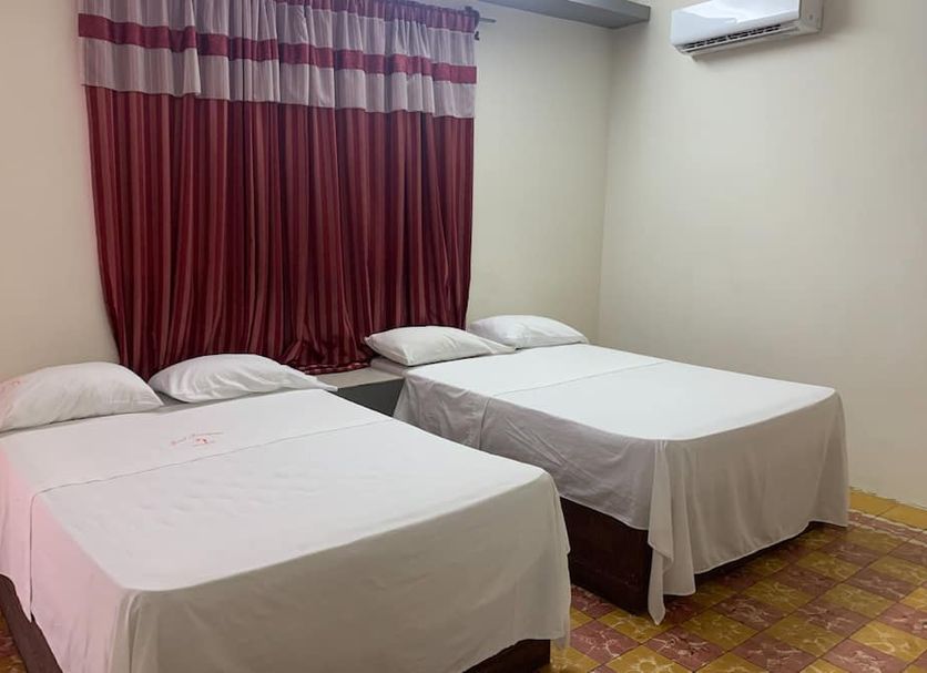 Hotel Papagayo in Veracruz guest room with two double beds and maroon curtains