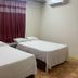Hotel Papagayo in Veracruz guest room with two double beds and maroon curtains