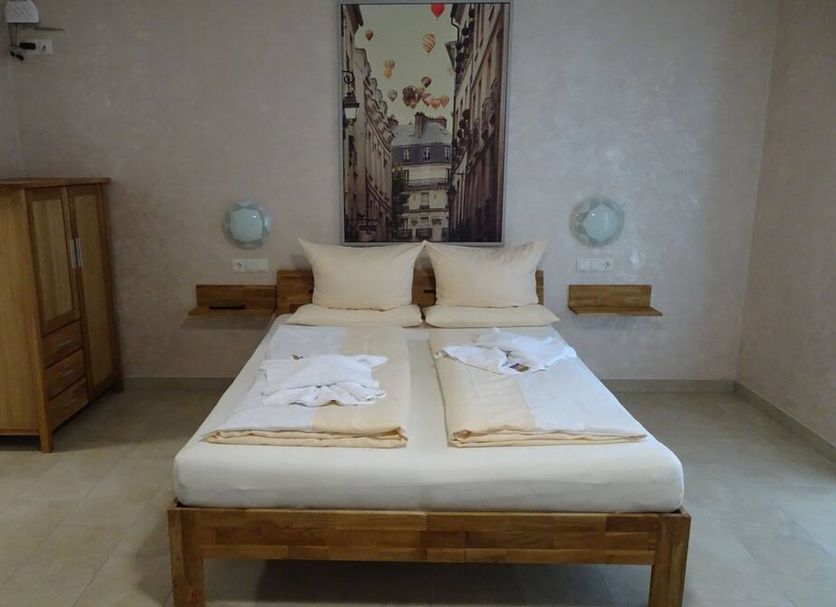 Hilda Apartments Rust bedroom with double bed, nightstands and wardrobe in Rust