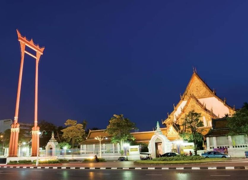 Excel Hotel Bangkok in Bangkok at night with illuminated Thai-style architecture and tall gateway