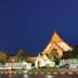 Excel Hotel Bangkok in Bangkok at night with illuminated Thai-style architecture and tall gateway