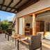 Woods at Sasan, Sasan Gir terrace with seating and sliding glass doors overlooking greenery