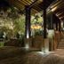 The Deer Park Hotel, Giritale: illuminated entrance walkway with stairs and covered timber roof at night