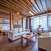 Lijiang Tianyu Boutique Hotel in Lijiang, wood-beamed suite with sofa, coffee table and large window
