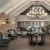 Protea Hotel by Marriott Bloemfontein lobby lounge with chandelier, vaulted ceiling, seating, and wood flooring