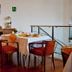 Hotel Boston Livorno dining area with table set for breakfast beside a lamp and wooden sideboard