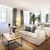 Petit Hôtel Confidentiel in Chambéry guest room with sofa, TV, desk, and twin beds