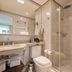 Melia Ibirapuera Sao Paulo bathroom with glass shower, toilet, sink and vanity mirror