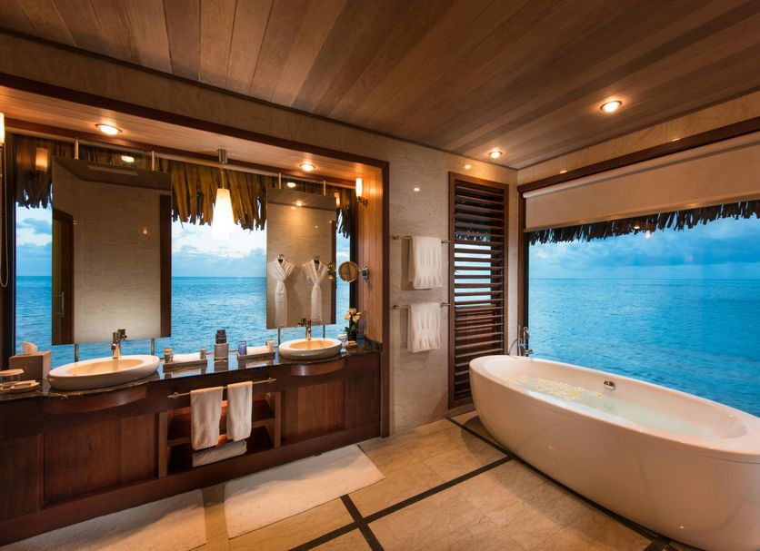 Conrad Bora Bora Nui in Vaitape: bathroom with freestanding tub and ocean view