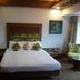 Hotel Airport Centre Point Nagpur guest room with bed, wall art, and seating area