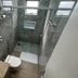 Pietro Angelo Hotel in Foz do Iguaçu bathroom with glass shower, wall-mounted toilet, and granite sink vanity