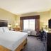 Best Western Plus Castle Rock guest room with king bed, desk, window seating, and TV