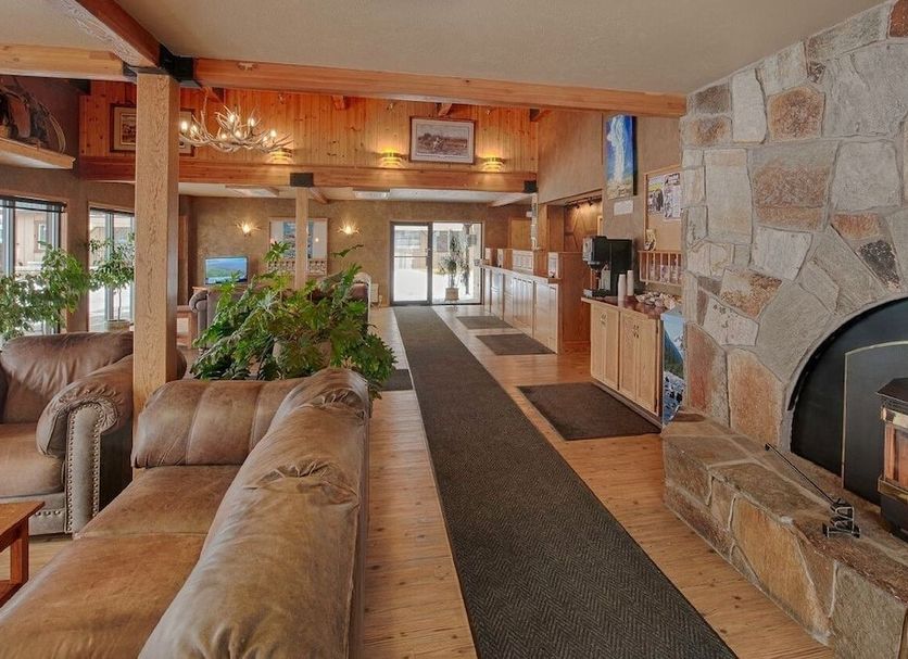Brandin' Iron Inn in West Yellowstone lobby with leather seating, stone fireplace and wood interiors
