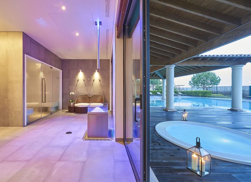 Cascade Wellness Resort in Lagos with indoor spa pool beside floor-to-ceiling glass and an outdoor pool view