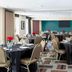 Four Points by Sheraton Buffalo Grove banquet room with round tables, black linens, and red floral centerpieces