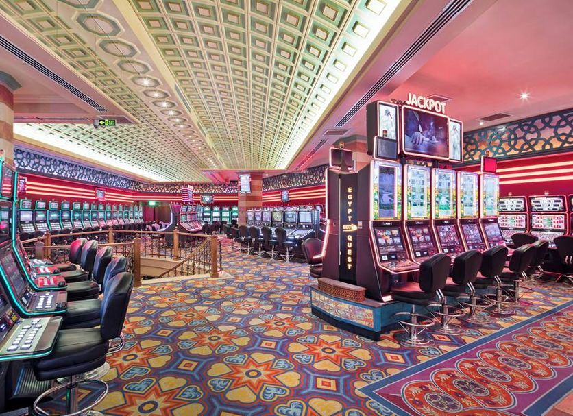 Merit Lefkosa Hotel & Casino casino floor in Nicosia with slot machines and colorful patterned carpet