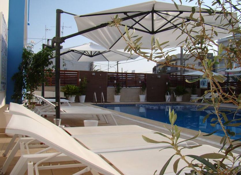 Aparthotel Fleming 50 - Adults Only poolside loungers and umbrellas in Sant Antoni de Portmany