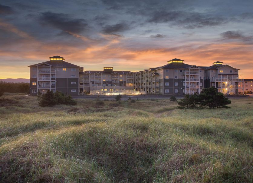 Worldmark Long Beach in Long Beach at sunset, set beyond grassy dunes