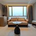 Huiwen Hotel in Shijiazhuang room with large window, sofa, and small round table