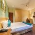 The Platinum Hotel Hyderabad room with bed, desk, TV, and small seating area