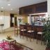 Hotel Orizzonte in Letojanni lobby lounge with bar, seating area and floral decor