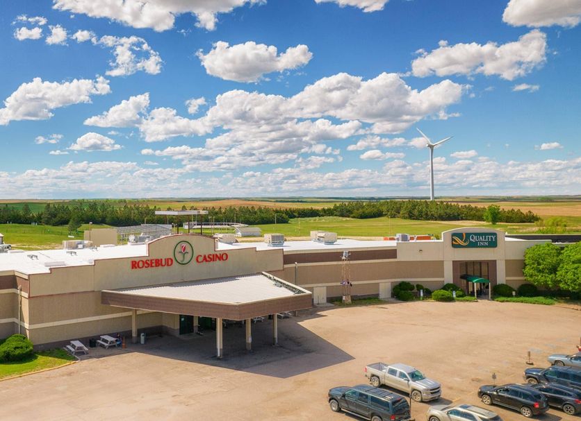 Quality Inn Rosebud Casino in Mission with casino entrance, parking lot, and prairie landscape