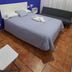The Dreamers&Co Córdoba guest room with double bed, sofa and blue accent wall