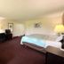 Knights Inn Kirksville room with king bed, desk, and seating area in Kirksville