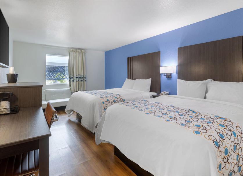 SureStay Plus by Best Western Niagara Falls East room with two beds, blue accent wall, and window view
