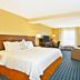 Fairfield Inn & Suites by Marriott Madison West/Middleton guest room with king bed, TV, desk and seating area in Middleton