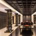 Crowne Plaza Kochi lobby with ornate black columns, central seating, and polished floor
