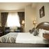 Cherry Maryski Hotel, Alexandria guest room with bed, desk, TV and window seating area
