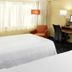 Fairfield Inn & Suites Parsippany guest room with two beds, desk, chair, and TV by window