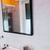L'Affittacamere di Venezia bathroom with glass shower, wall mirror, and white tiled walls in Venice