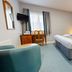 Yarnfield Park Training And Conference Centre room in Stone with double bed, desk, chair and blue accent wall