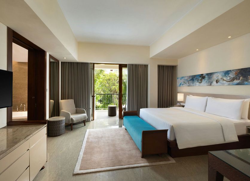 Courtyard by Marriott Bali Nusa Dua Resort room with balcony, king bed, and seating area in South Kuta