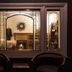 Stewart Inn in Wausau: cozy fireplace room seen through a decorative window