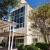 Baymont by Wyndham San Antonio Airport exterior with entrance canopy, trees, and multi-story windows