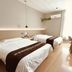 Super 8 by Wyndham Qingdao Jiaonan Heng Li Yuan guest room with two beds and desk in Qingdao