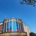 Wuyue Yuexin Hotel (Jinggangshan) in Ji'an, exterior with curved glass facade and blue sky