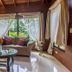 Hotel El Silencio del Campo in La Fortuna lounge with sofa, glass coffee table and garden-view windows