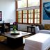 Villas Sur Mer in Negril living room with sofa, TV, coffee table and large windows