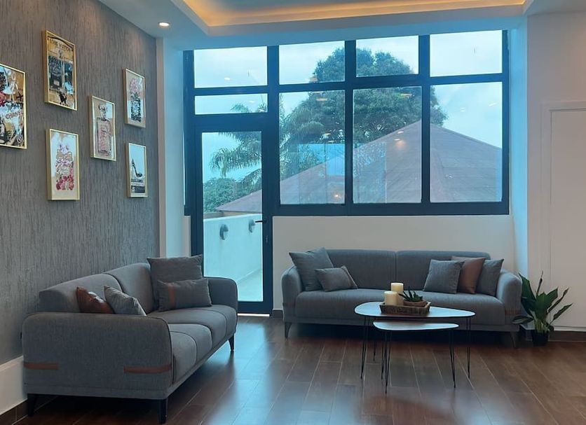 Grand Lancaster Brazzaville lounge with sofas, coffee table and large windows in Brazzaville