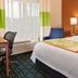 Fairfield Inn & Suites by Marriott Harrisonburg guest room with king bed, desk, chairs and window seat