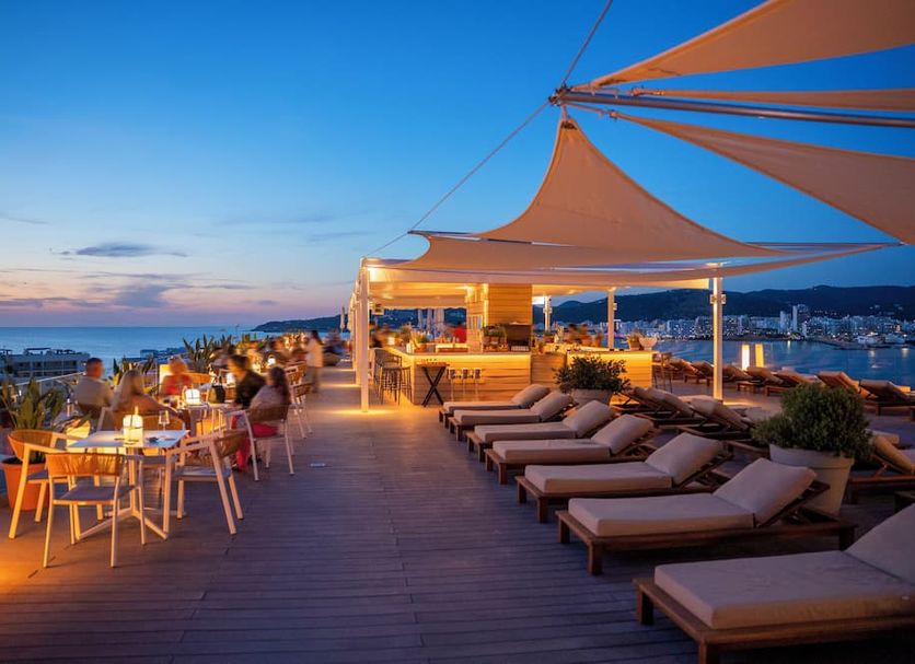 INNSiDE Ibiza Beach rooftop terrace with loungers, dining tables and sunset sea views in Ibiza