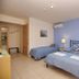 4 Epoches Hotel Alonissos room with twin beds, bedside lamps and blue walls in Steni Vala