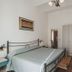 Hotel Alfiero, Porto Santo Stefano: simple guest room with double bed, wardrobe, desk, and wood floors.