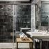 Exe Las Margas Golf Hotel bathroom with glass shower, sink, and towel bench in Latas