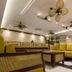 1898 Hotel Colonia En Las Filipinas lobby lounge in Makati with yellow sofas, tables and ceiling fans